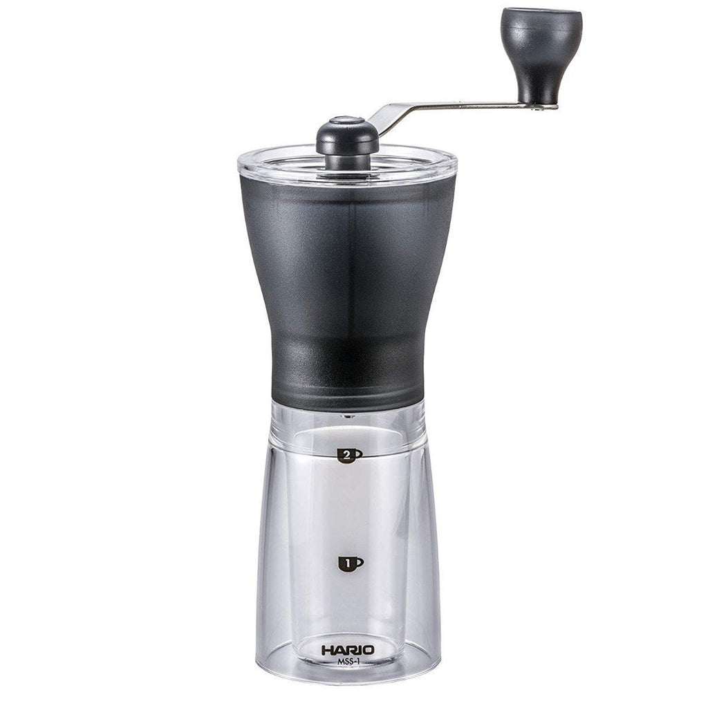Hario Mini Slim+ manual coffee grinder with black handle and transparent grounds container
