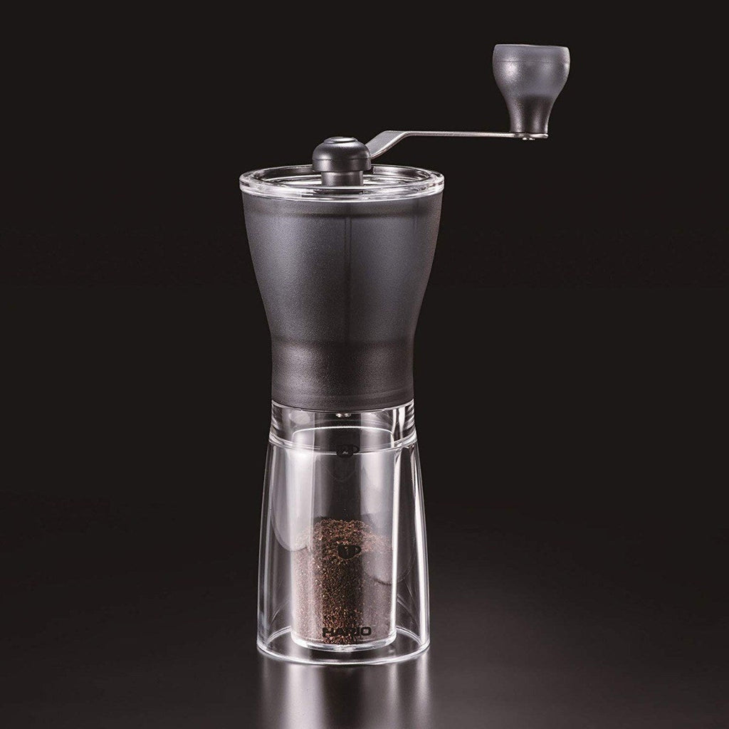 Hario Mini Slim+ manual coffee grinder on a dark background