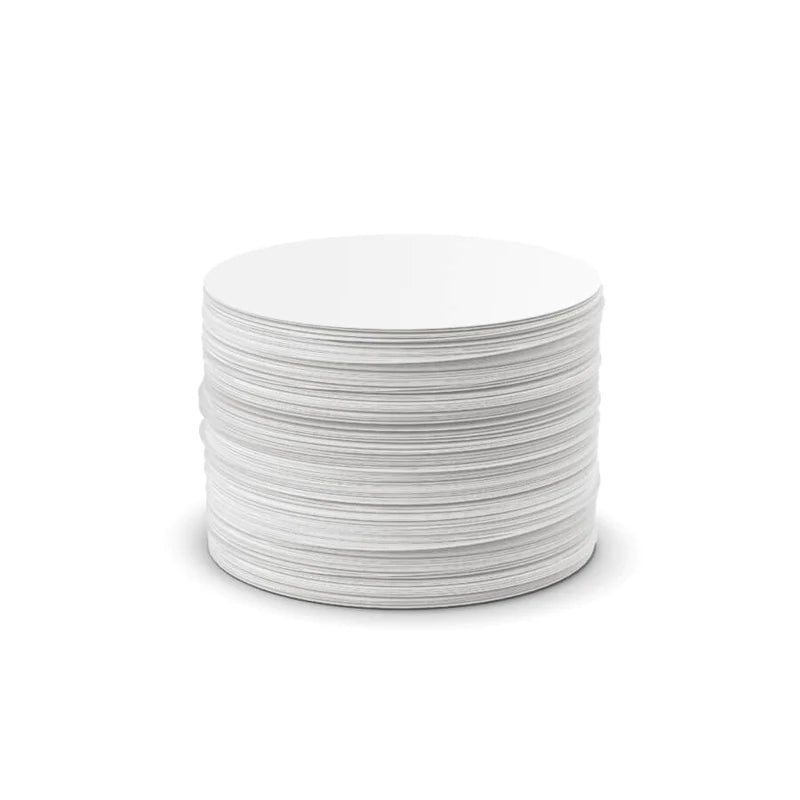 Stack of white AeroPress standard paper micro-filters on a white background.