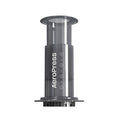 AeroPress Original coffee brewer with clear chamber, plunger and filter cap, on a white background.