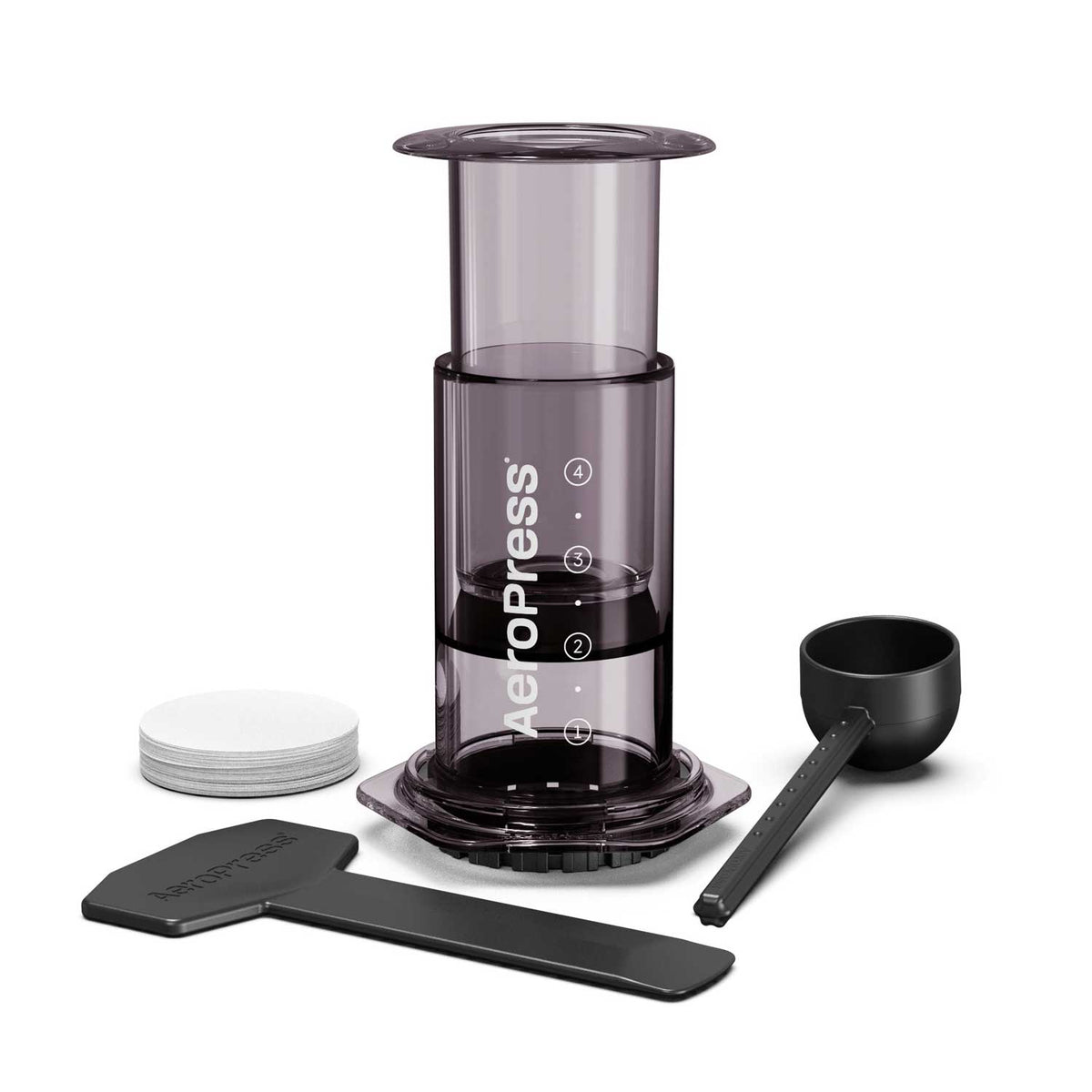 AeroPress Original shown with paper micro-filters, a measuring scoop, a stirrer and a funnel.