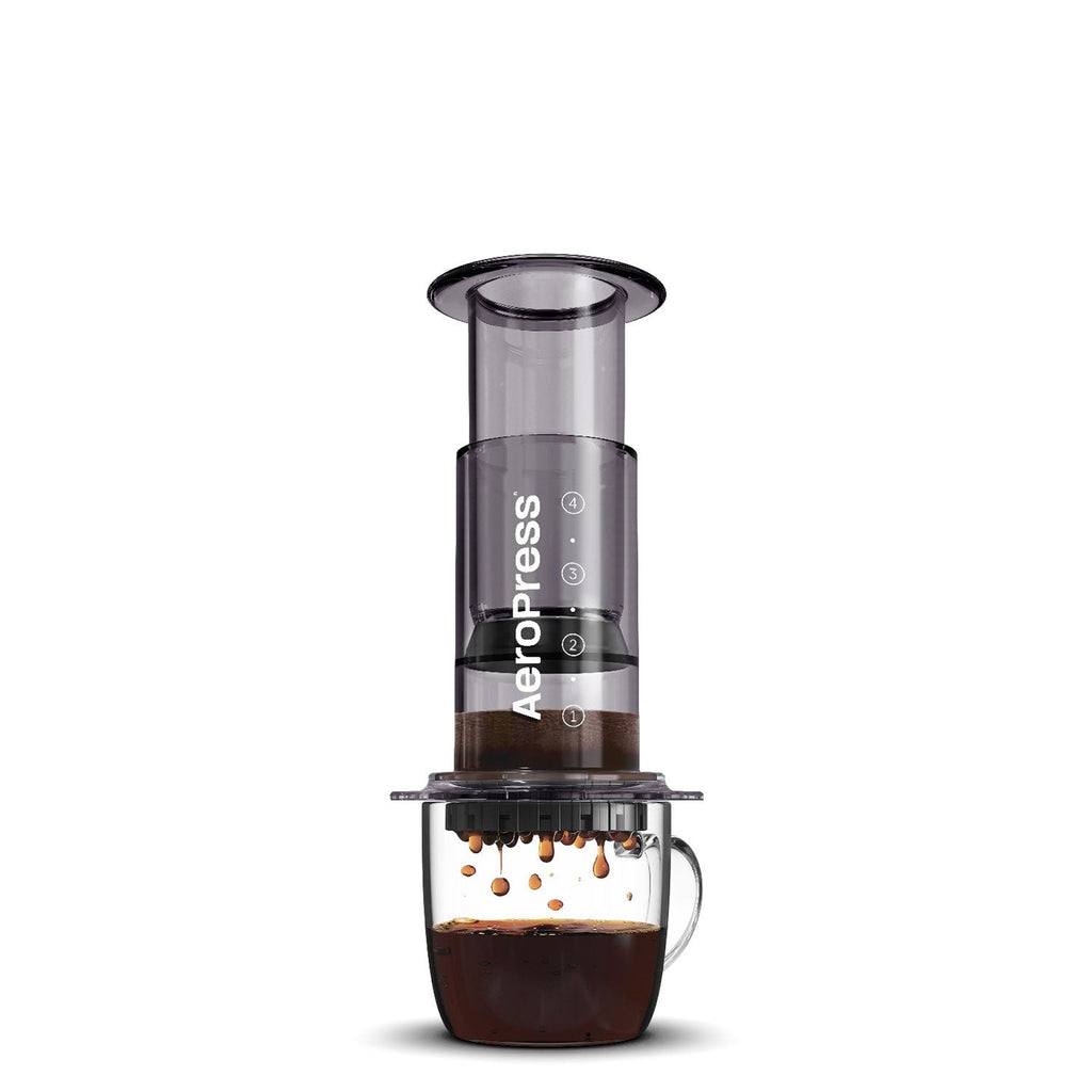 AeroPress Original brewing coffee into a clear glass mug; mug not included.