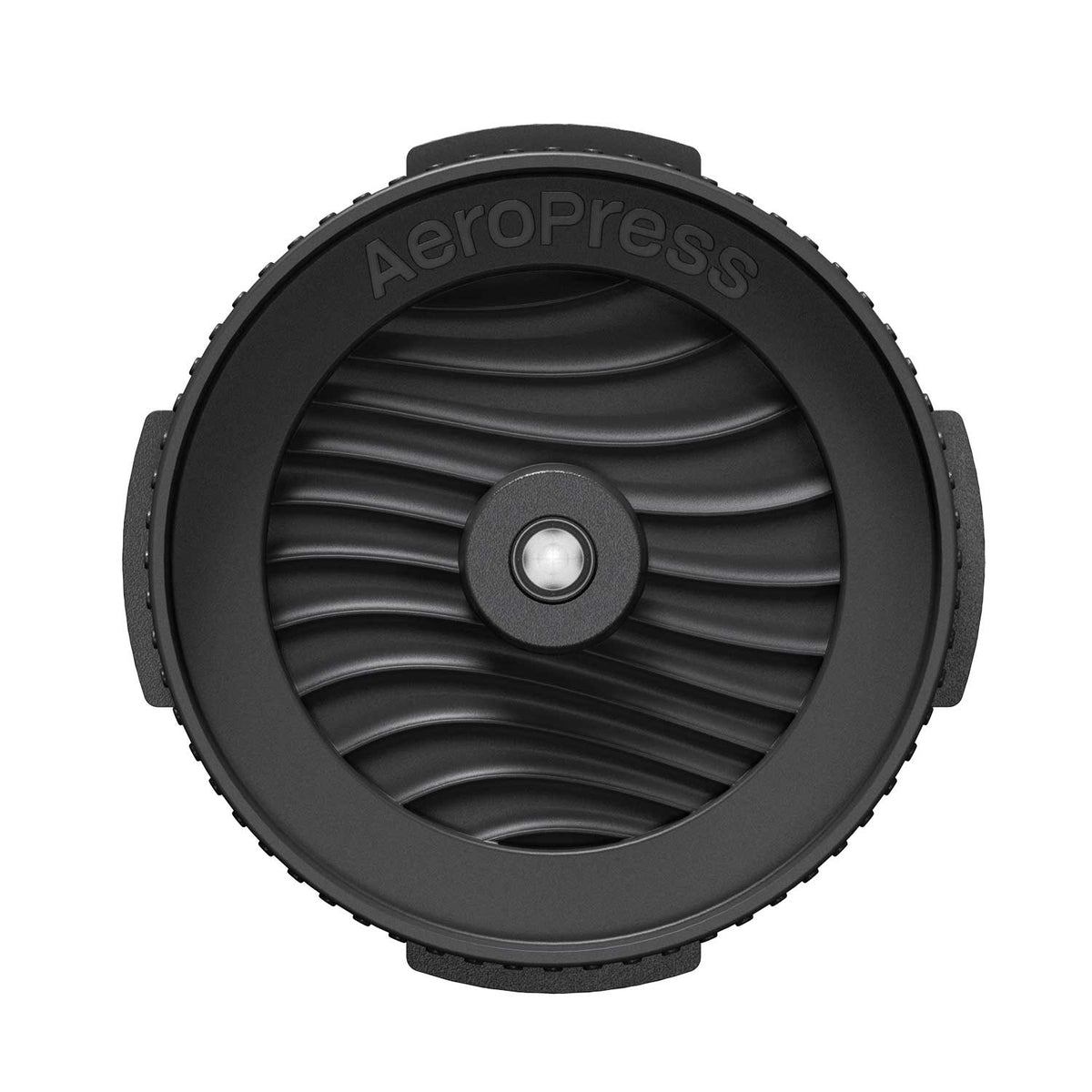 Top view of the AeroPress Flow Control Filter Cap showing its ridged rim and wave-patterned valve face.