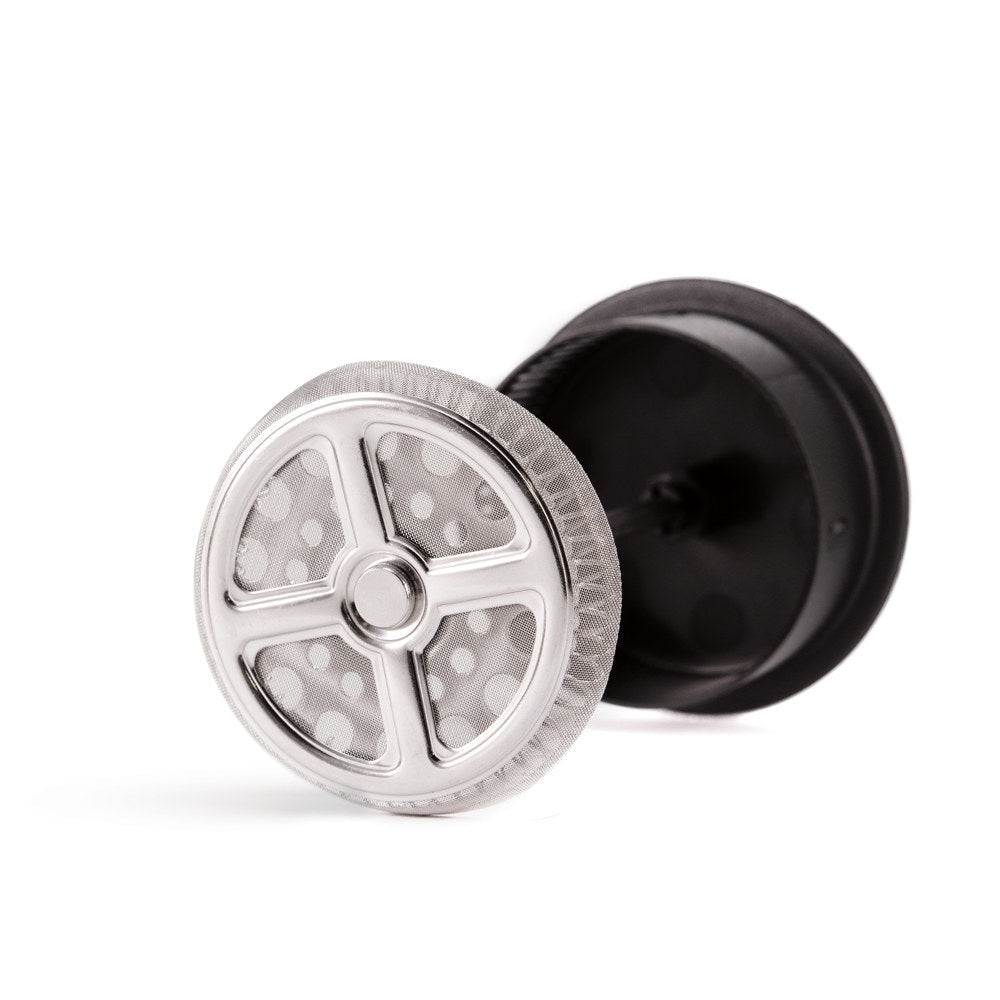 Yama French press stainless steel mesh filter disc beside its black base component.