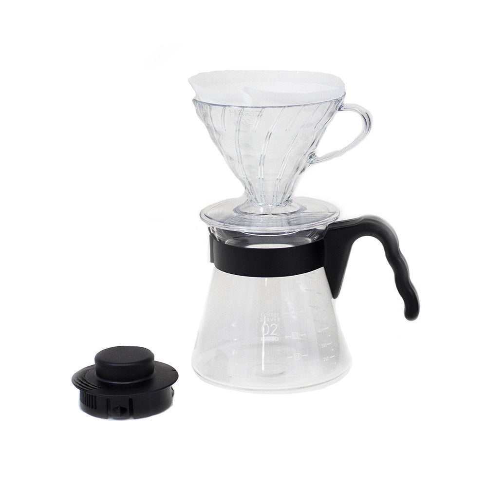 Hario V60 02 pour-over starter kit: clear V60 02 dripper, glass range server with black handle, and black measuring scoop.
