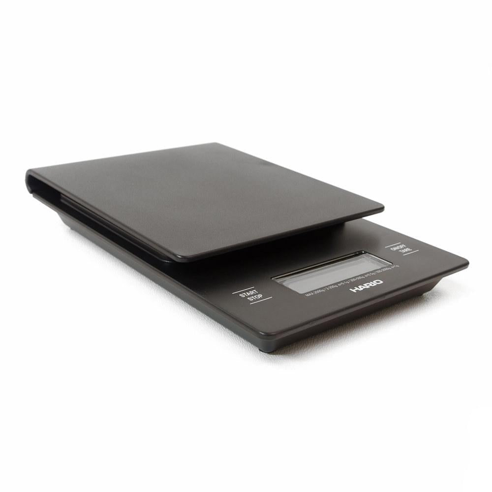 Black Hario V60 drip scale and timer viewed from above at an angle on a white background.