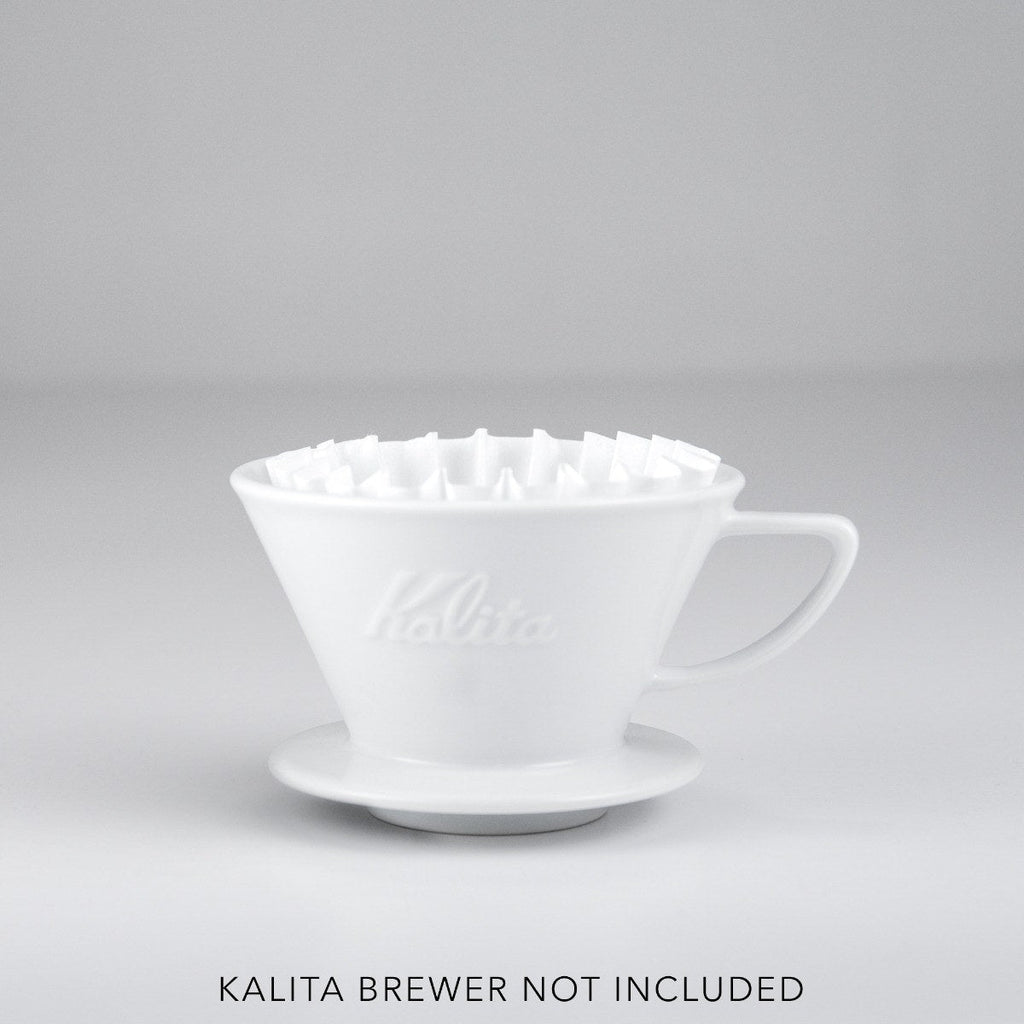 White Kalita Wave paper filter seated in a white Kalita ceramic brewer; brewer not included.