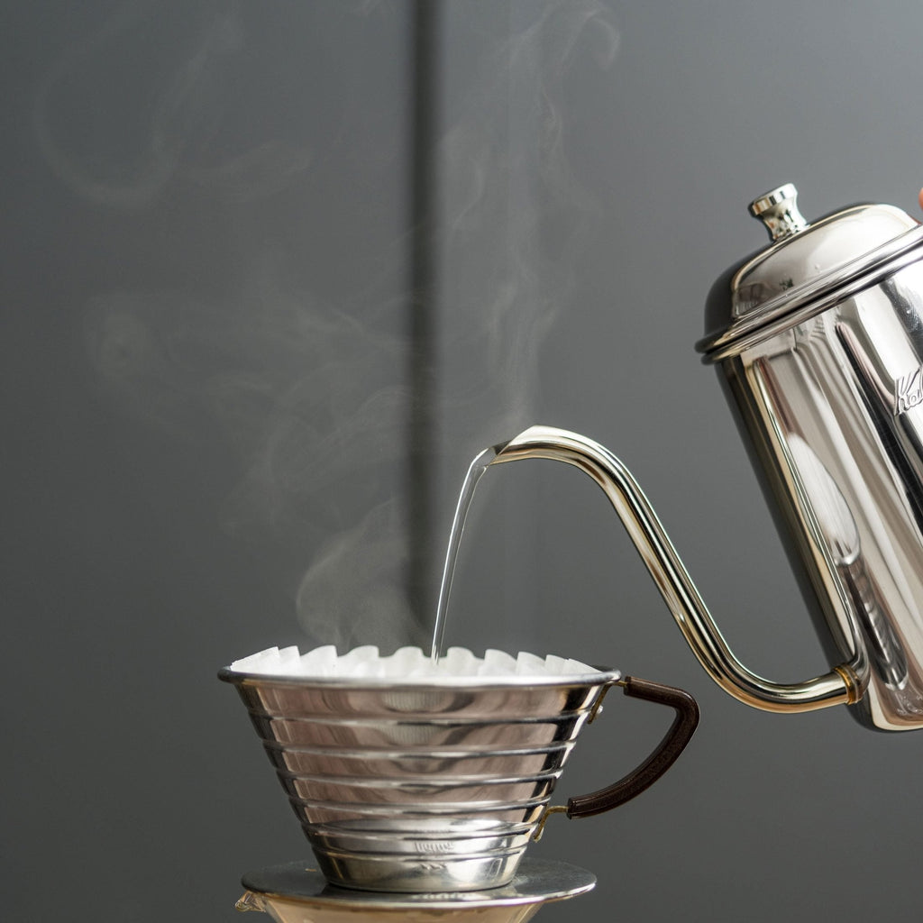 Gooseneck kettle pouring hot water into a Kalita Wave 185 dripper; kettle, server and filters not included.